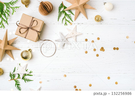 Festive Christmas background with gift box and Christmas decorations Festive Christmas background with gift box and Christmas decorations 132256986