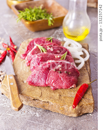 Raw meat on a table with spices 132257142