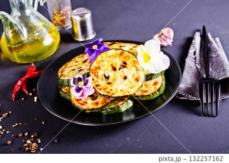 Roasted zucchini slices, rings, close-up view. 132257162