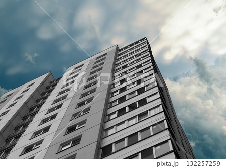 Building rises under sunny sky. Modern highrise architecture showcases concrete multistorey block 132257259