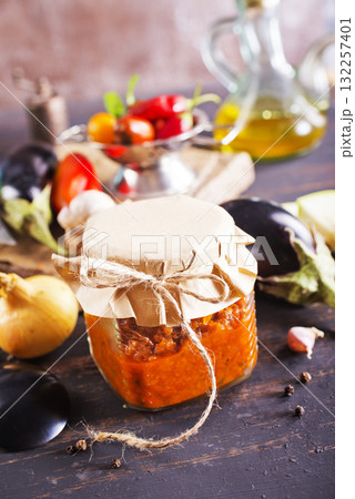 Dish with squash caviar dark background. Squash spread, zucchini caviar and ingredients. Healthy food. Top view 132257401