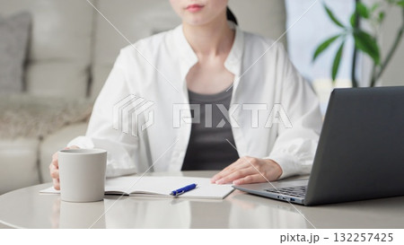 勉強中に一息つくアジア人女性 勉強中に一息つくアジア人女性 132257425