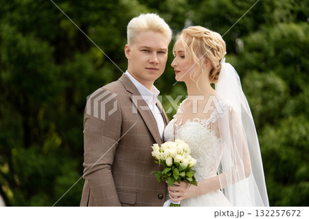 Elegant outdoor wedding ceremony between a couple in a serene garden 132257672