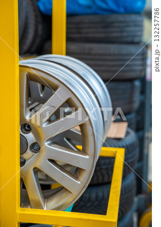 Closeup of clean car rims stacked in a tire workshop. Seasonal wheel replacement and maintenance in auto service before winter in Czech Republic. 132257786