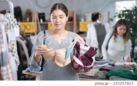 Young woman chooses underwear in clothing store 132257821