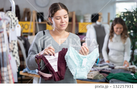 Young woman chooses panties in clothing store 132257931
