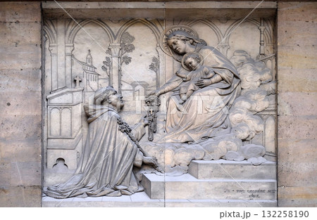 The Virgin giving the Rosary to Saint Dominic, by Theodore Charles Gruyere, relief on the portal of Saint Thomas Aquinas in Paris, France 132258190