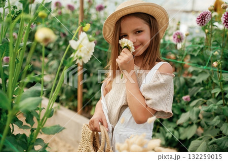 Little girl is in the greenhouse 132259015