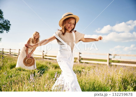 Running, having fun. Beautiful mother with her daughter on the farm Running, having fun. Beautiful mother with her daughter on the farm 132259678
