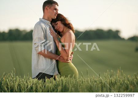 Conception of relationships. Lovely couple are on the agricultural field together Conception of relationships. Lovely couple are on the agricultural field together 132259997