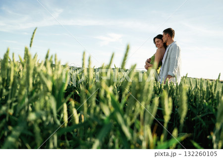 Conception of relationships. Lovely couple are on the agricultural field together 132260105