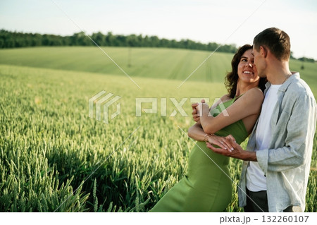 Non urban scene. Lovely couple are on the agricultural field together Non urban scene. Lovely couple are on the agricultural field together 132260107