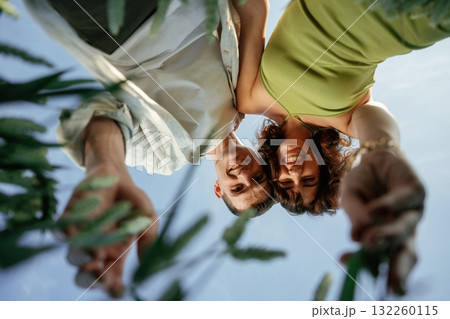 View from below of couple that is standing in the agricultural field 132260115