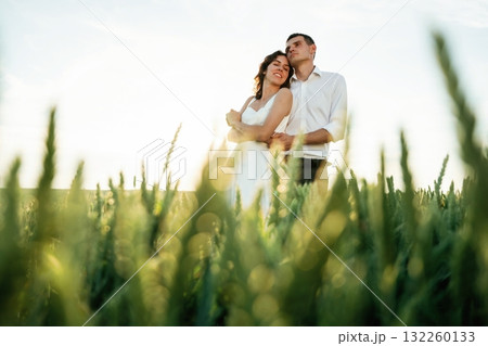 High wheat. Lovely couple are on the agricultural field together 132260133