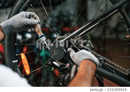 The derailleur issue, fixing. Close up view of man's hands that is repairing bicycle The derailleur issue, fixing. Close up view of man's hands that is repairing bicycle 132260424