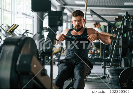 Exercise for stamina. Strong muscular man is working out in the gym Exercise for stamina. Strong muscular man is working out in the gym 132260503