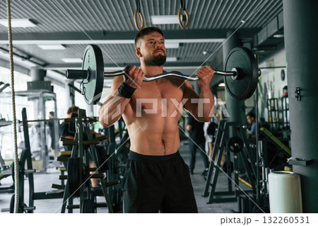 Muscular strong man is working out in the gym Muscular strong man is working out in the gym 132260531