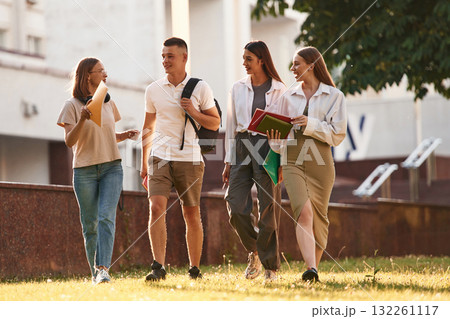 Cheerful, having fun. Group of students are outside together 132261117