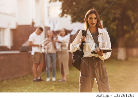 Posing, standing. Group of students are outside together 132261263