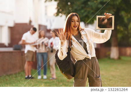 Posing, standing. Group of students are outside together 132261264