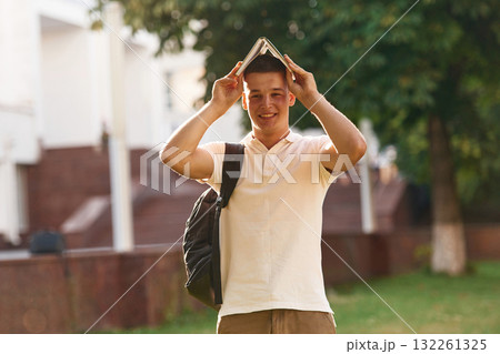 Young male student is outdoors Young male student is outdoors 132261325