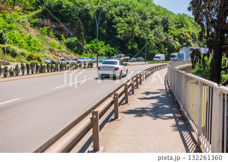 Sunny street with hillside view. Urban living, nature integration, and relaxed Mediterranean lifestyle in a coastal neighborhood. 132261360