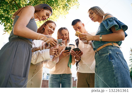 Bunch of smartphones. Group of students are outside together 132261361