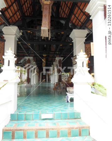 Grand Temple Entrance with Teal Tiled Floor and Ornate Columns Under Tiled Roof 132261514