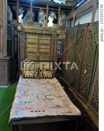 A Vintage Wooden Bed with Elephant Pillows and a Patchwork Quilt in an Antique Market Display A Vintage Wooden Bed with Elephant Pillows and a Patchwork Quilt in an Antique Market Display 132261538