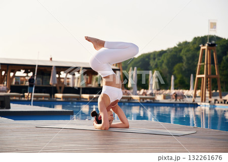On the head, side, view. Fitness woman is near the pool 132261676