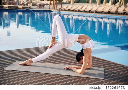 Legs and arms exercise. Fitness woman is near the pool 132261678