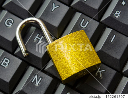 Top view of padlock on keyboard background symbolizing restricted entry, secure login or digital safety system. Top view of padlock on keyboard background symbolizing restricted entry, secure login or digital safety system. 132261807