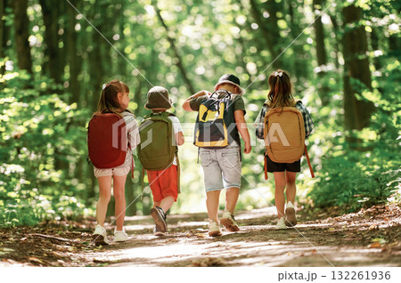 Conception of hiking. Kids in forest at summer daytime together 132261936