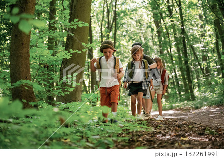 Bunch of green plants and leaves. Kids in forest at summer daytime together 132261991