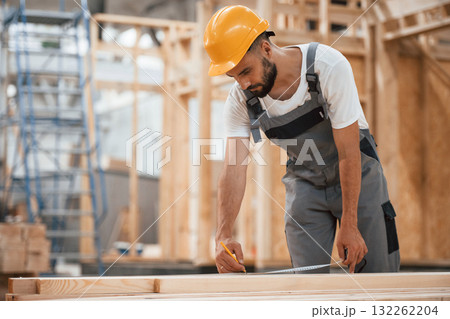 Contractor is busy. Industrial worker in wooden warehouse Contractor is busy. Industrial worker in wooden warehouse 132262204