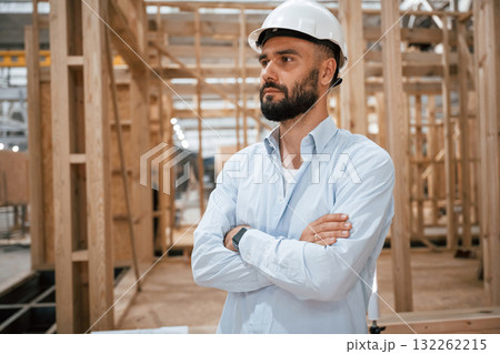 Portrait, with arms crossed. Industrial worker in wooden warehouse Portrait, with arms crossed. Industrial worker in wooden warehouse 132262215