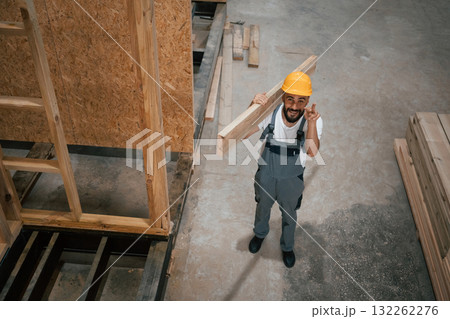 In yellow hardhat. Industrial worker in wooden warehouse 132262276