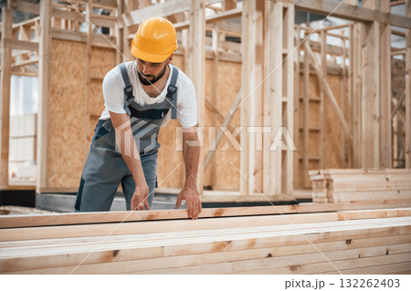 The wooden plank. Industrial worker in warehouse The wooden plank. Industrial worker in warehouse 132262403