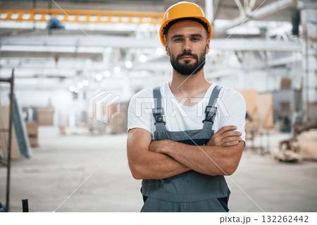 Portrait, with arms crossed. Industrial worker in wooden warehouse 132262442