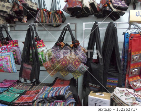 Market Stall Displaying Colorful Handmade Bags with Intricate Patterns 132262717