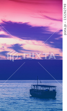 Beautiful Sea of Galilee in the morning in Northern Israel. Seascape with the boat during sunrise. Gradient color. Vertical banner 132262749