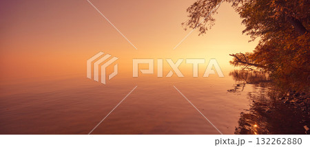 Minimalist landscape. Serene lake during sunrise. Magic sunrise over the lake. Misty early morning. Horizontal banner Minimalist landscape. Serene lake during sunrise. Magic sunrise over the lake. Misty early morning. Horizontal banner 132262880