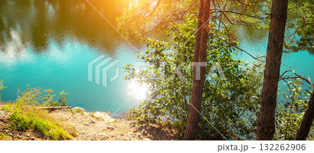 Beautiful lakeshore of mountain lake. Rural landscape in autumn. Wilderness, serenity lake. Horizontal banner Beautiful lakeshore of mountain lake. Rural landscape in autumn. Wilderness, serenity lake. Horizontal banner 132262906