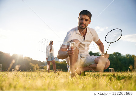 Man with woman are playing badminton on the field 132263669
