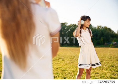 Fun, with tin can phone. Happy kids are on the summer field Fun, with tin can phone. Happy kids are on the summer field 132263739