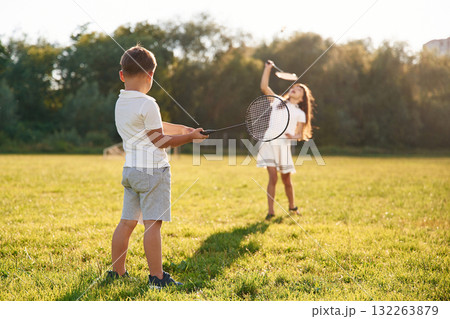 Happy kids are on the summer field Happy kids are on the summer field 132263879