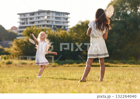 Game of badminton. Happy kids are on the summer field 132264040