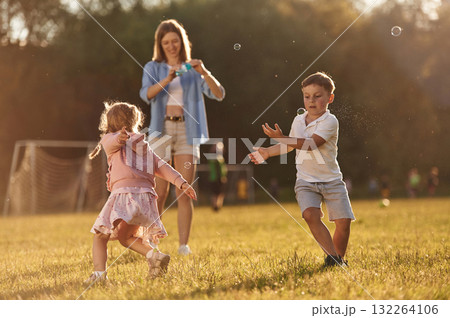 Woman with kids is on the summer field 132264106