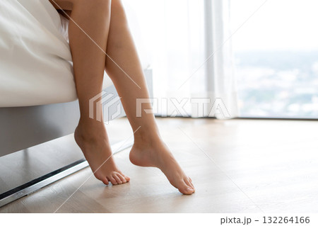 Young caucasian woman sitting peaceful on bed in bedroom for relax in morning. 132264166