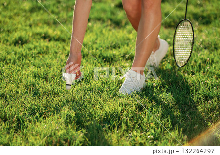 Close up view of woman that is taking shuttlecock from the ground Close up view of woman that is taking shuttlecock from the ground 132264297
